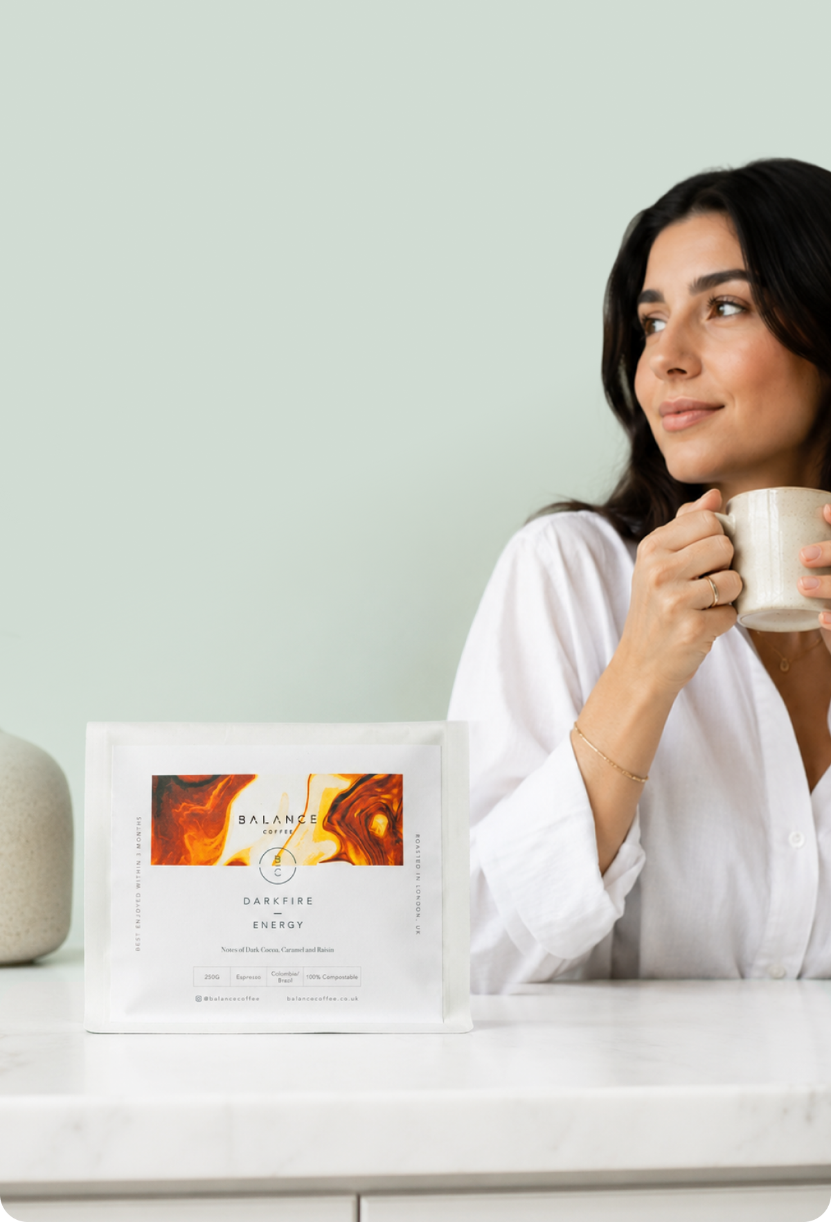 Balance Coffee Darkfire Energy bag with a customer enjoying a cup
